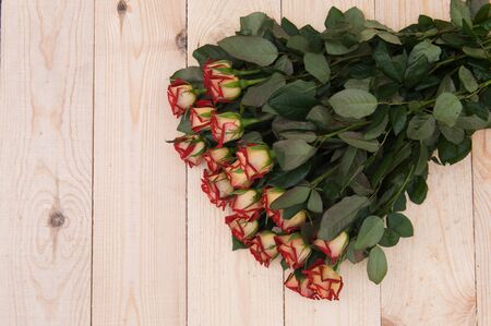 Beautiful red roses on a dark wooden table, with space for textの写真素材