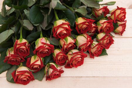Beautiful red roses on a dark wooden table, with space for textの写真素材