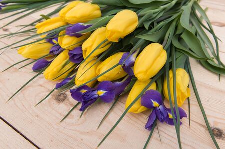 Beautiful yellow tulips on wooden background. Top view, copy spaceの写真素材