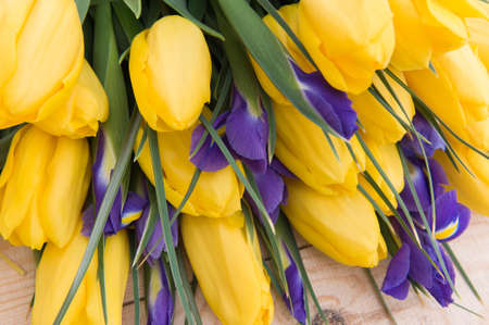 Beautiful yellow tulips on wooden background. Top view, copy spaceの写真素材