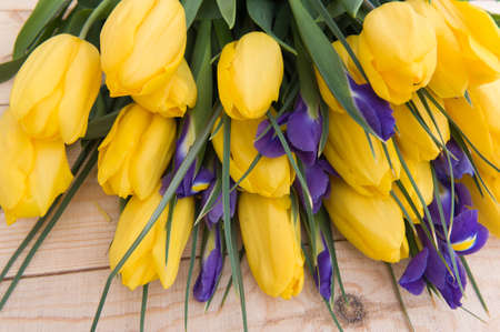 Beautiful yellow tulips on wooden background. Top view, copy spaceの写真素材