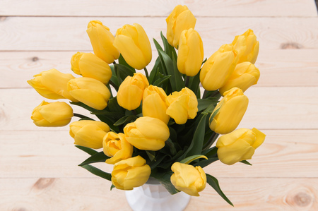Beautiful yellow tulips on wooden background. Top view, copy spaceの写真素材