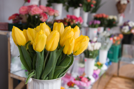 elegant bouquet of tulips on the background of other flowers.の写真素材