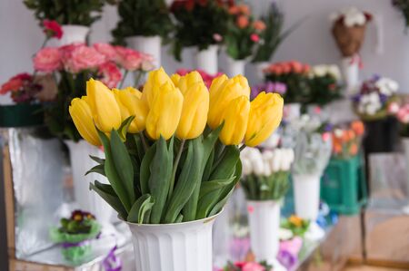 elegant bouquet of tulips on the background of other flowers.の写真素材