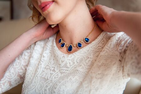 bridesmaids help to wear a wedding dress in the morningの写真素材