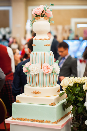 Beautiful delicious white wedding cake ceremony at the tableの写真素材