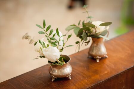 three small vase with flowers standing near electric lampsの写真素材