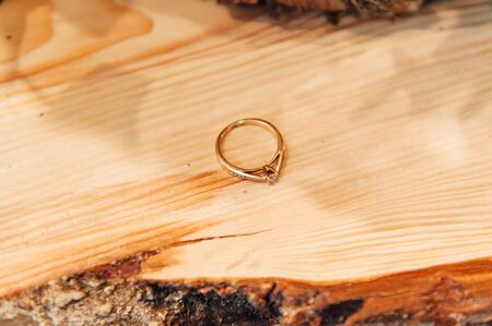 Wedding rings on the wooden frame with bokeh backgroundの写真素材