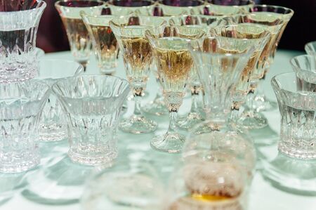 Wedding glasses filled with champagne at banquet or another eventの写真素材