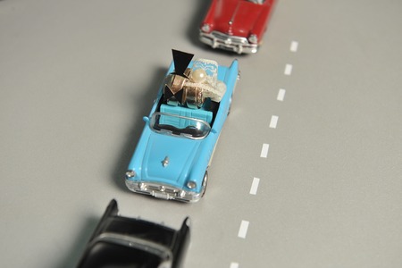 gold wedding rings lie in the small blue toy car. to funny decorationsの写真素材