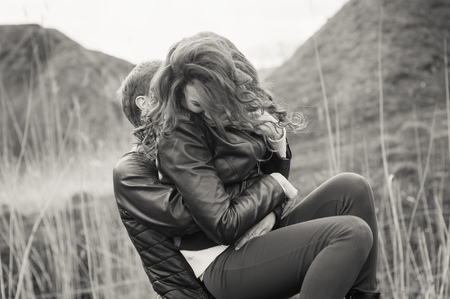 Happy couple smiling outdoors on hiking trip in the mountainsの写真素材