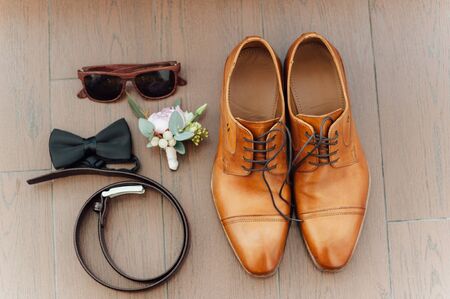 Set of groom clothes. Wedding rings, shoes, cufflinks and bow tie detalis fashionの写真素材