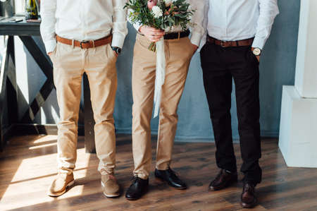Beautiful wedding bouquet in hands of the groom. with his friends