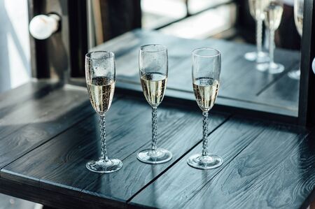 Wedding glasses filled with champagne at the banquetの写真素材