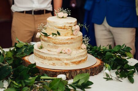 Beautiful delicious white wedding cake ceremony at the tableの写真素材