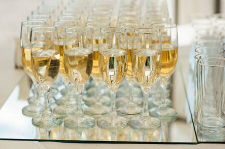 Wedding glasses filled with champagne at the banquetの写真素材