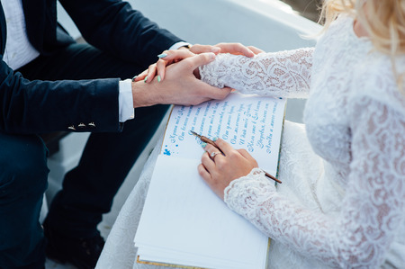 Woman writes on a paper her boyfriend congratulatory letterの写真素材