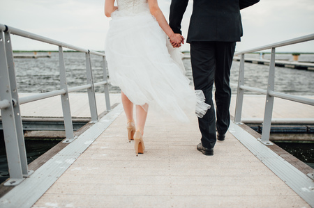 llovers hold hands and walk in the park sunsetの写真素材