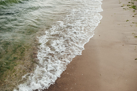 Soft wave of the sea on the sandy beach.