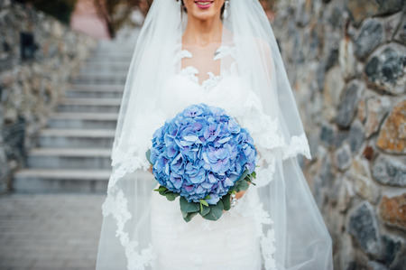 beautiful bouquet in hands of the bride is very stylish with light hairの写真素材