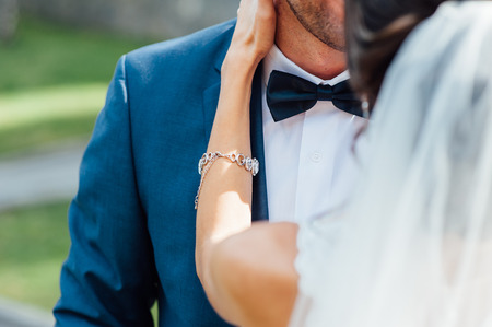 Bride and groom at wedding Day walking Outdoors on spring nature. Bridal couple, Happy Newlywed woman and man embracing in green park. Loving wedding couple outdoor. Bride and groomの写真素材