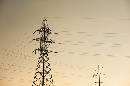 metal Bearing high voltage power line during sunset or sunrise.