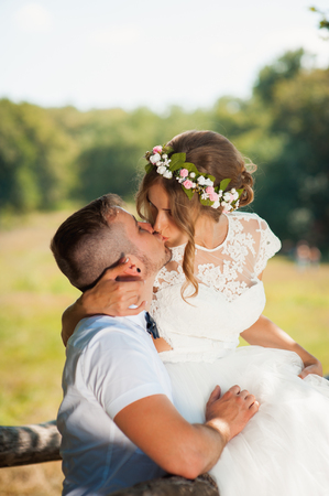 Bride and groom at wedding Day walking Outdoors on spring nature. Bridal couple, Happy Newlywed woman and man embracing in green park. Loving wedding couple outdoor. Bride and groomの写真素材