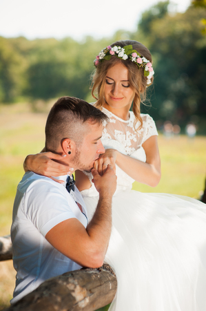 Bride and groom at wedding Day walking Outdoors on spring nature. Bridal couple, Happy Newlywed woman and man embracing in green park. Loving wedding couple outdoor. Bride and groomの写真素材