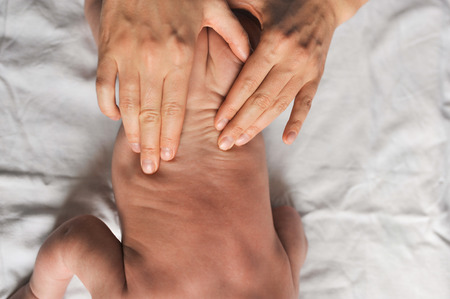 doctor makes small baby kid massage healthy.の写真素材