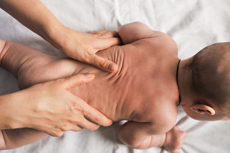 doctor makes small baby kid massage healthy.の写真素材