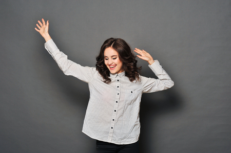 Portrait of attractive brunette businesswoman indicating OK sign isolated on white background. she is happy because it has successfully completed the taskの写真素材