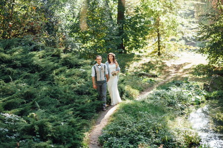 love, relationship, family and people concept - happy couple walking in summer parkの写真素材