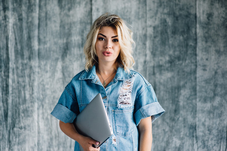 Cute pretty girl with laptop smilingの写真素材