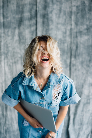 Cute pretty girl with laptop smilingの写真素材