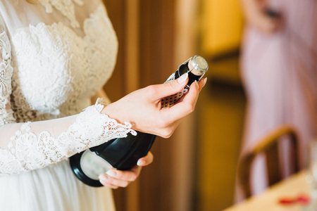 The bride and girlfriend drink champagne. Close-upの写真素材