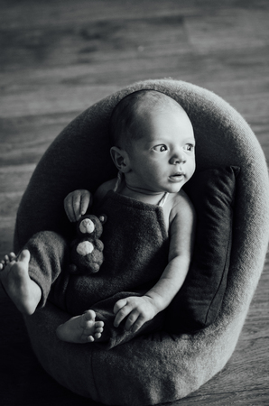 cute newborn looks surprised at the cameraの写真素材