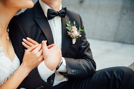 newlyweds hugging and sitting on a wooden board.の写真素材