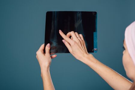 beautiful female doctor holding a scan