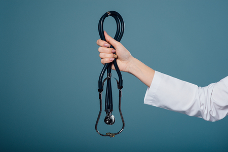 female doctors hand holds a stethoscopeの写真素材