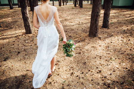 beautiful bouquet in hands of the bride is very stylish with light hairの写真素材
