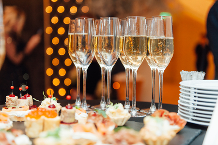 Wedding glasses filled with champagne at banquetの写真素材