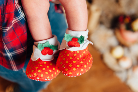 Beautiful cute baby feet in funny socksの写真素材