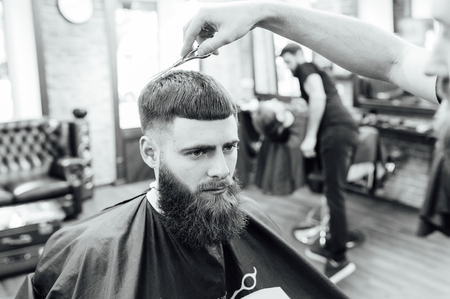 man getting trendy haircut at barber shop.の写真素材