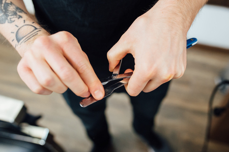 Barber prepares dangerous razor for shaving beardの写真素材
