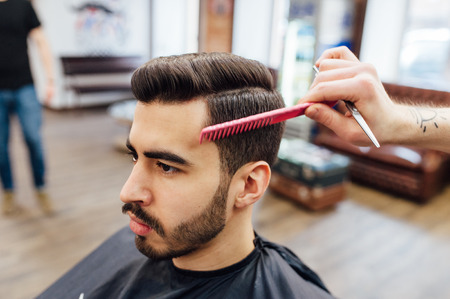 male model shows a haircut in a barber shopの写真素材