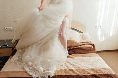 very sexy bride puts on a white dressの写真素材