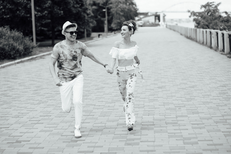 Couple holding hands outdoor. Young couple runningの写真素材