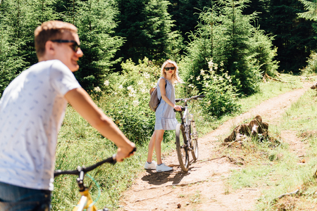 young couple  ride on bicycles in the mountainsの写真素材