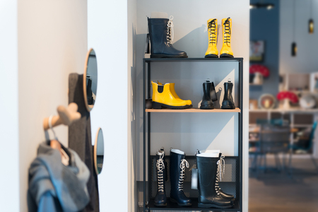 Stylish shelving with shoes and clothes in the apartmentsの写真素材