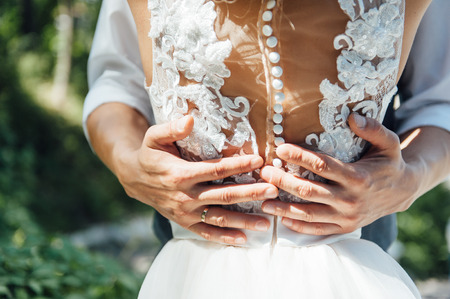 Bride and groom are hugging during the dayの写真素材